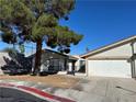 Charming single-story home featuring a well-manicured lawn and an attached two-car garage at 5720 Goldmount Ave, Las Vegas, NV 89107