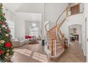 Bright foyer with tile flooring, curved staircase, and views to the living room at 59 Desert Dawn Ln, Henderson, NV 89074