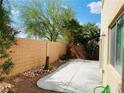 Backyard featuring concrete patio, desert landscaping, and block wall at 6245 Blushing Willow St, North Las Vegas, NV 89081