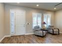 Living area featuring plank floors, shutters on windows, and two patterned accent chairs at 6403 Brandon Hills Ct, Las Vegas, NV 89139