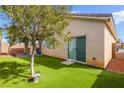 Private backyard with well kept artificial grass and desert landscaping perfect for relaxing or entertaining at 6711 Quarterhorse Ln, Las Vegas, NV 89148