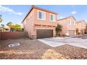 Two-story home featuring a brown garage door, concrete driveway, and low maintenance landscaping at 744 Forest Peak St, Henderson, NV 89011