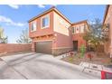 Two-story home featuring a brown garage door and tastefully landscaped yard with desert-themed plants at 744 Forest Peak St, Henderson, NV 89011