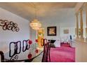 Elegant dining room with chandelier and views into other living spaces at 750 S Royal Crest Cir # 345, Las Vegas, NV 89169