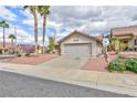 Charming single Gathering home showcases a two car garage, low maintenance yard, and desert landscaping at 802 Blue Springs Dr, Henderson, NV 89002