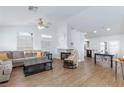 Bright living room features a modern fireplace, light wood floors, and opens to the kitchen at 802 Blue Springs Dr, Henderson, NV 89002
