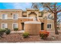 Condominium exterior showcasing a tan facade and well-maintained landscaping at 8070 W Russell Rd # 2015, Las Vegas, NV 89113