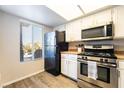 Kitchen with stainless steel oven and microwave, updated cabinets, and view from window at 8070 W Russell Rd # 2015, Las Vegas, NV 89113