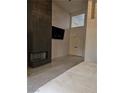 Modern fireplace and TV as a focal point in this spacious main bedroom at 8170 Round Hills Cir, Las Vegas, NV 89113