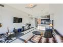 Open-concept living room featuring a leather sofa, area rug, and views into the kitchen at 8255 Las Vegas Blvd # 1504, Las Vegas, NV 89123