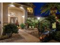 Beautiful home entrance with double doors, manicured landscaping, and elegant lighting at 9475 Windham Heights Ct, Las Vegas, NV 89139