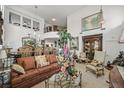 Spacious living room with comfortable seating, elegant decor, and a view of the second-floor balcony at 1465 Via Savona Dr, Henderson, NV 89052