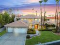 Beautiful two-story home showcasing manicured landscaping and a three-car garage, offering both elegance and convenience at 2221 Glenbrook Way, Las Vegas, NV 89117