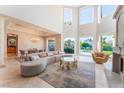 Elegant living room featuring high ceilings, fireplace, and seamless indoor-outdoor flow to the pool area at 2221 Glenbrook Way, Las Vegas, NV 89117