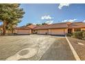 Charming townhome showcasing two-car garage and well-manicured landscaping creating a welcoming curb appeal at 2611 Laguna Shores Ln, Las Vegas, NV 89121