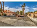 Picturesque street view showcases the well-maintained landscaping and gated entrances of this lovely community at 2611 Laguna Shores Ln, Las Vegas, NV 89121