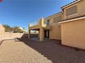 Spacious backyard features gravel landscaping and a covered patio, ideal for outdoor relaxation at 2628 Park Hyatt Ave, North Las Vegas, NV 89081