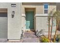Close-up of home's front door features brick steps, desert landscaping, and a modern door at 2682 Weathered Copper Ave, North Las Vegas, NV 89086