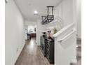 Hallway featuring hard surface flooring, beverage center, and view into kitchen area at 2682 Weathered Copper Ave, North Las Vegas, NV 89086