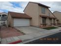 A spacious two-story home showcasing a two-car garage, red tile roof, and a concrete driveway at 2711 Sesame Dr, Las Vegas, NV 89142
