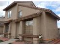 A close up view of a well-kept house with a red tiled roof and covered entryway with desert landscaping at 2711 Sesame Dr, Las Vegas, NV 89142