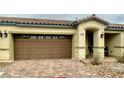 Lovely single story home featuring a two car garage, tan exterior, and brick paver landing at 2790 Chetco River St, Laughlin, NV 89029
