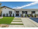 Close-up of modern walkway and manicured lawn leading to front door at 2870 Belcastro St, Las Vegas, NV 89117