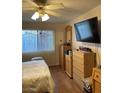 Bedroom with wood laminate flooring, closet, chest of drawers, and a ceiling fan at 3748 E Hacienda Ave, Las Vegas, NV 89120