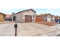 Inviting single-story home featuring a spacious driveway and desert landscaping at 4153 Broadriver Dr, Las Vegas, NV 89108
