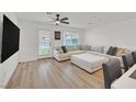 Bright living room featuring a large sectional sofa, modern ceiling fan, and a patio door for outdoor access at 4932 Chidlaw Ave # 2, Las Vegas, NV 89115