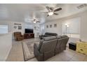 Spacious living room featuring neutral walls, tile flooring, a ceiling fan, and comfortable seating area at 5224 Jose Ernesto St, North Las Vegas, NV 89031