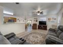 Open-concept living area boasts tile floors, a ceiling fan, and a view of the adjacent kitchen at 5224 Jose Ernesto St, North Las Vegas, NV 89031