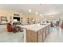 Bright, open kitchen featuring an island with modern countertops and stainless steel sink at 5450 Barnwood Ct, Pahrump, NV 89061