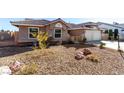Charming single-story home featuring desert landscaping, tile roof, and a two-car garage at 5552 Singing Hills Dr, Las Vegas, NV 89130