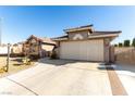 Front view of a single-story home showing a two-car garage, gated entrance, and desert landscaping at 5552 Singing Hills Dr, Las Vegas, NV 89130