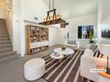 Bright living room featuring modern furnishings, a large window, and contemporary decor at 6236 Sereno Springs St, North Las Vegas, NV 89081