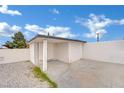Exterior view of a stucco outbuilding with two entrances and rock landscaping at 7060 S Valley View Blvd, Las Vegas, NV 89118