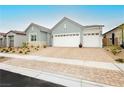 Attractive single-story home with a three-car garage and a spacious brick-paved driveway at 856 Watford Pl, Henderson, NV 89011