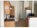 Bright kitchen with wooden cabinets, essential appliances, and practical countertop space at 8680 Horizon Wind Ave # 101, Las Vegas, NV 89178