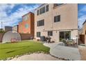Backyard featuring artificial turf, grilling area, and a patio, perfect for outdoor gatherings at 9051 Iron Cactus Ave, Las Vegas, NV 89148
