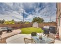 Spacious backyard with artificial turf, patio area, and barbecue, great for outdoor entertaining at 9051 Iron Cactus Ave, Las Vegas, NV 89148