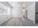 Sunlit living room featuring stylish gray floors, a ceiling fan, and neutral paint palette at 9071 Mount Wilson St, Las Vegas, NV 89113