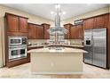 Spacious kitchen boasts granite countertops, stainless steel appliances, and ample cabinet space at 9172 Tudor Park Pl, Las Vegas, NV 89145
