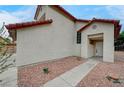 Close-up shot of the home's entrance with low-maintenance landscaping and a concrete walkway at 9529 Shallow Brook Cir, Las Vegas, NV 89117