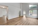 Bright living room with high ceilings, wood-look floors, and large windows at 9529 Shallow Brook Cir, Las Vegas, NV 89117