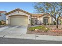 Inviting single-story home with a two-car garage and well-maintained landscaping at 9920 Netherton Dr, Las Vegas, NV 89134