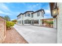 View of the backyard showcasing ample parking space and an attached, covered outdoor area at 10639 Isola Bella St, Las Vegas, NV 89141