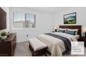 Comfortable bedroom with a queen-sized bed, dresser, and a window overlooking the outdoors at 12367 Indigo Montage Rd # 3, Las Vegas, NV 89183