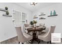 Bright dining area with a round wooden table, comfortable seating, and natural light from the window at 12367 Indigo Montage Rd # 3, Las Vegas, NV 89183
