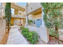 View of condo building exterior with landscaping along walkway at 1817 Cutlass Dr # 0, Henderson, NV 89014